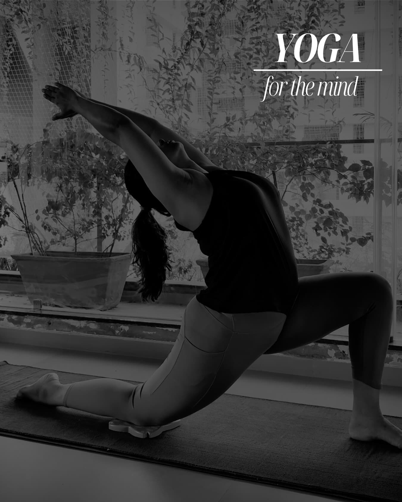 Black-and-white photo of a woman in a low lunge, reaching one arm overhead toward the window, captioned "Yoga — for the mind".